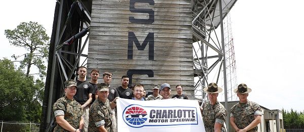 RFK Racing driver Chris Buescher and Charlotte Motor Speedway Executive Vice President and General Greg Walter presented a Mission 600 flag to Marines at Marine Corps Recruit Depot, Parris Island during a Mission 600 visit ahead of next weekend's Coca-Cola 600 at America's Home for Racing.