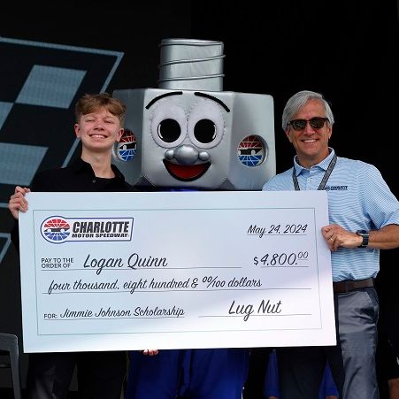 Charlotte Motor Speedway Executive Vice President and General Manager Greg Walter (right) presented Mount Pleasant High School senior Logan Quinn with a Jimmie Johnson Scholarship worth $4,800 ahead of this weekend's Coca-Cola 600. 
