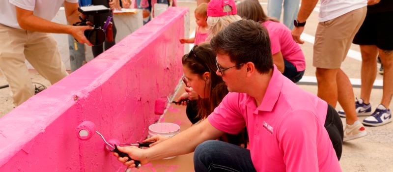 Erik Jones paints pit wall during the 12th annual Paint Pit Wall Pink event in conjunction with Blue Cross NC, sponsor of the Oct. 12 Drive for the Cure 250 at Charlotte Motor Speedway.